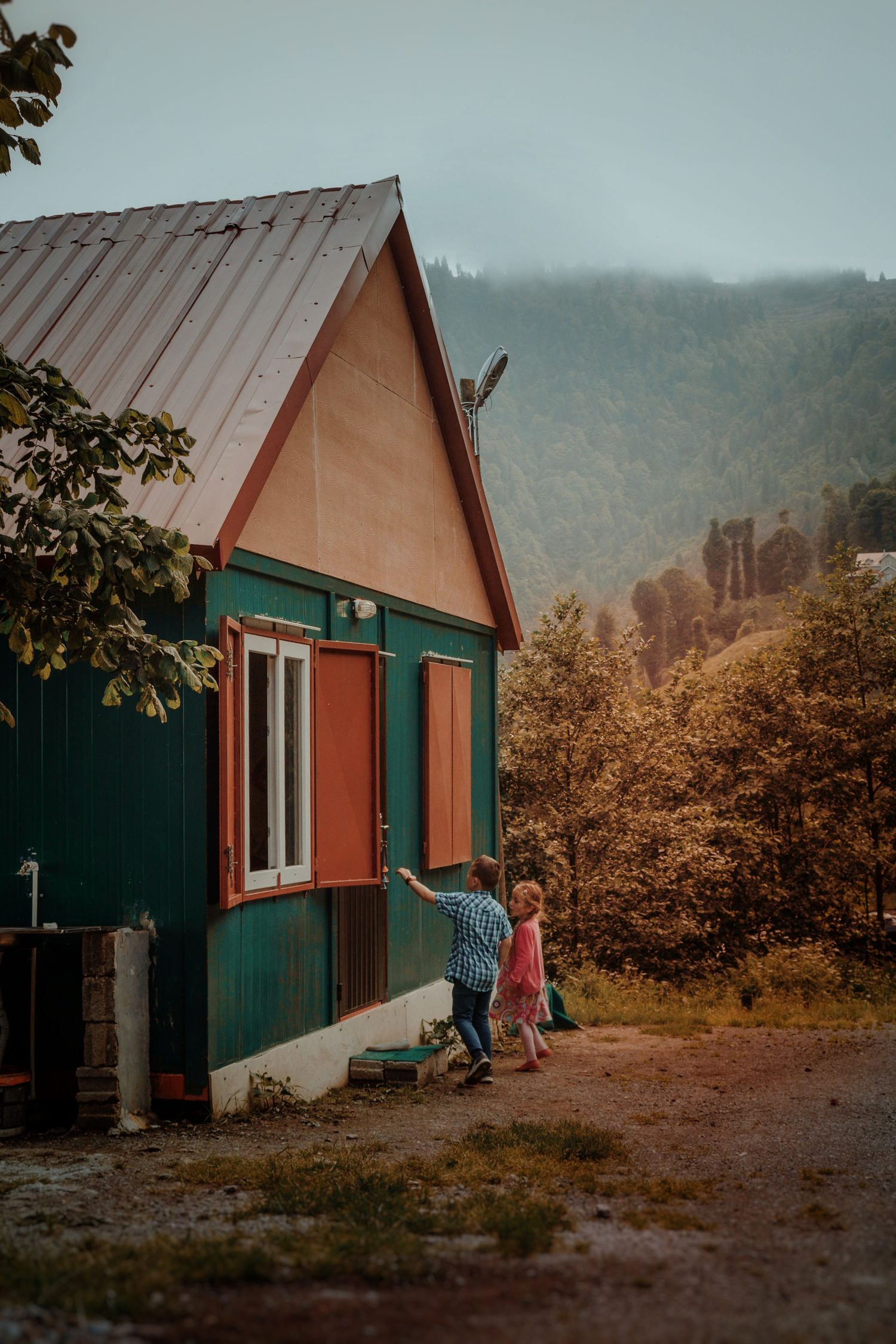 Children playing outside a finished home